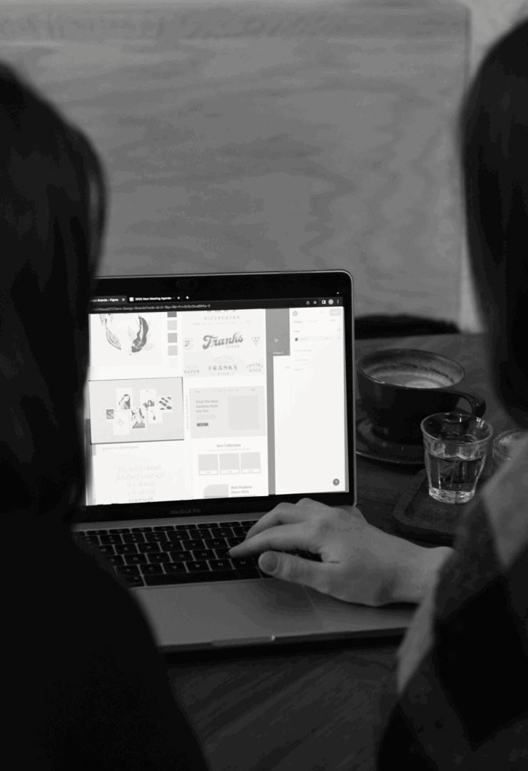 Website designers at Glazed Design Co. collaborating on a laptop
